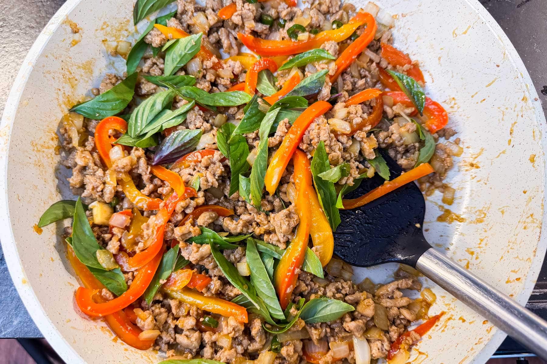 Fresh Thai basil leaves tossed into the finished stir-fry in the skillet