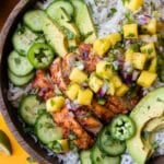 Chipotle mango chicken rice bowls with fresh mango salsa, cucumbers, and avocado.