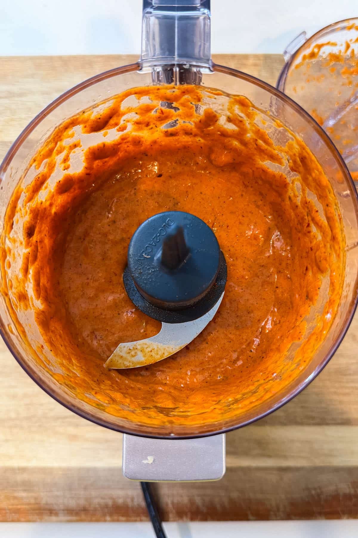 The chipotle mango marinade blended smooth in a food processor for Mango Chipotle Chicken Rice Bowls.