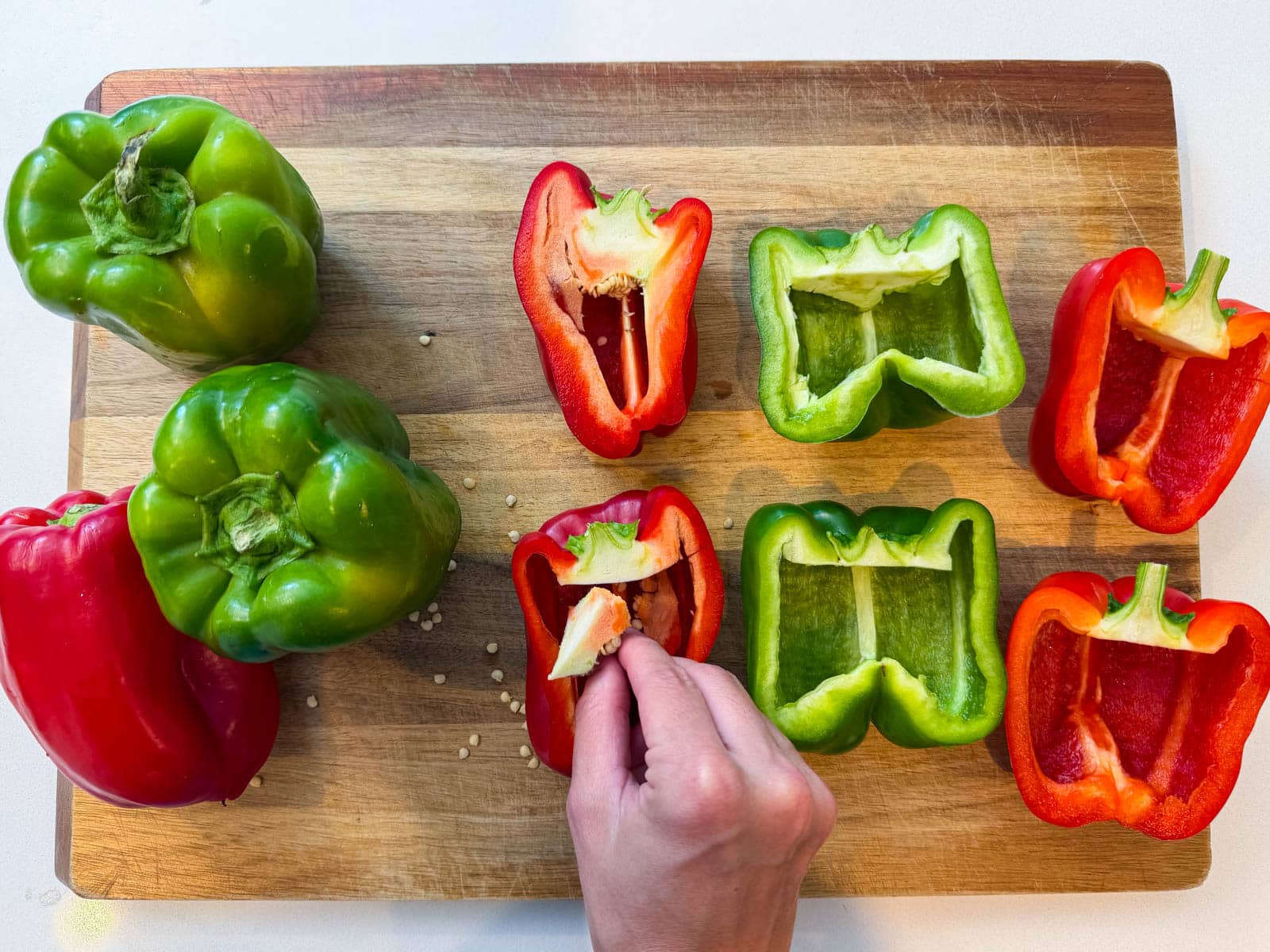 Bell peppers are cut in half and prepped for a stuffed peppers recipe.