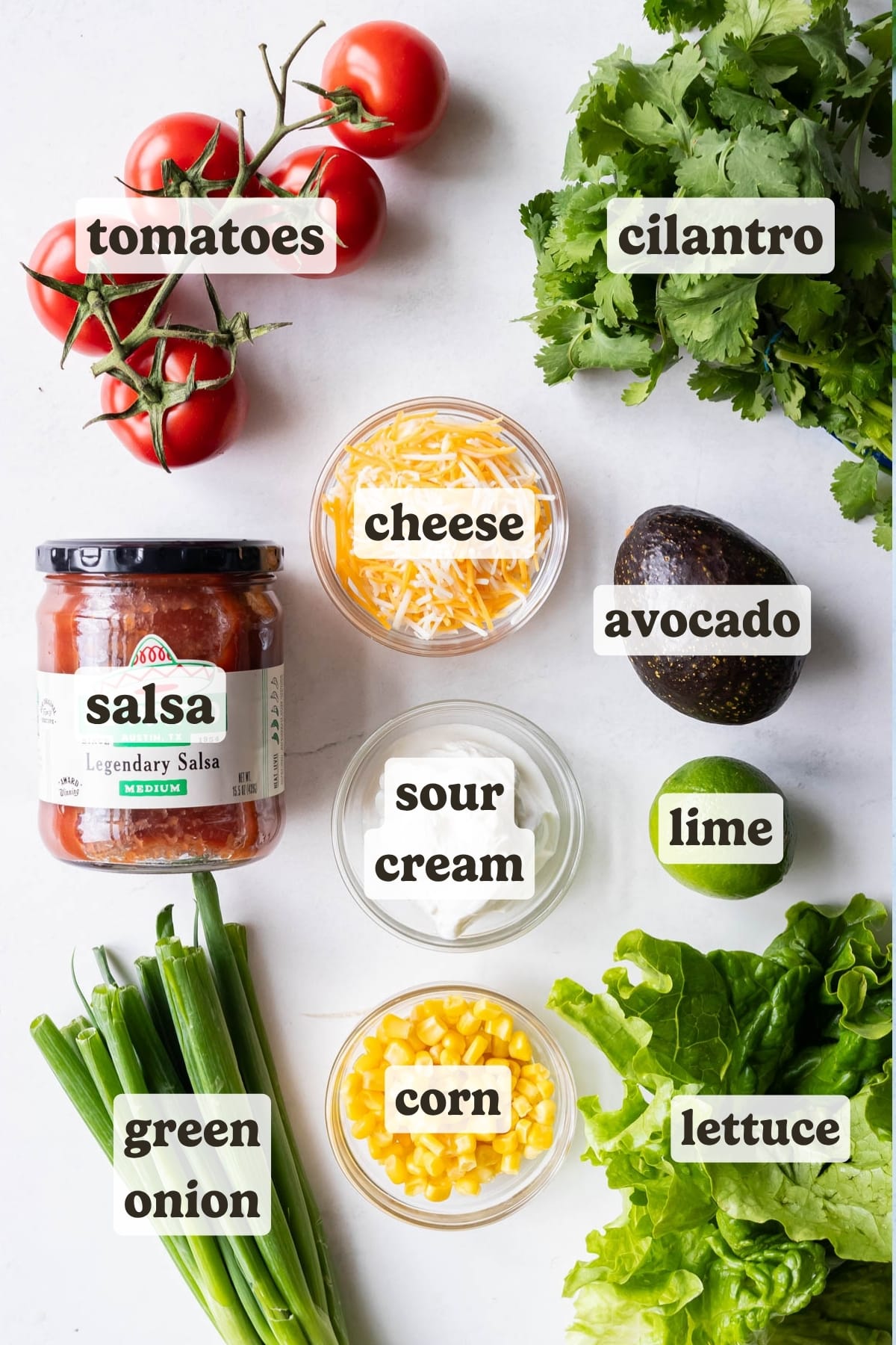 Tomato, lettuce, cheese, corn, salsa, and cilantro are the main ingredients for this taco salad.