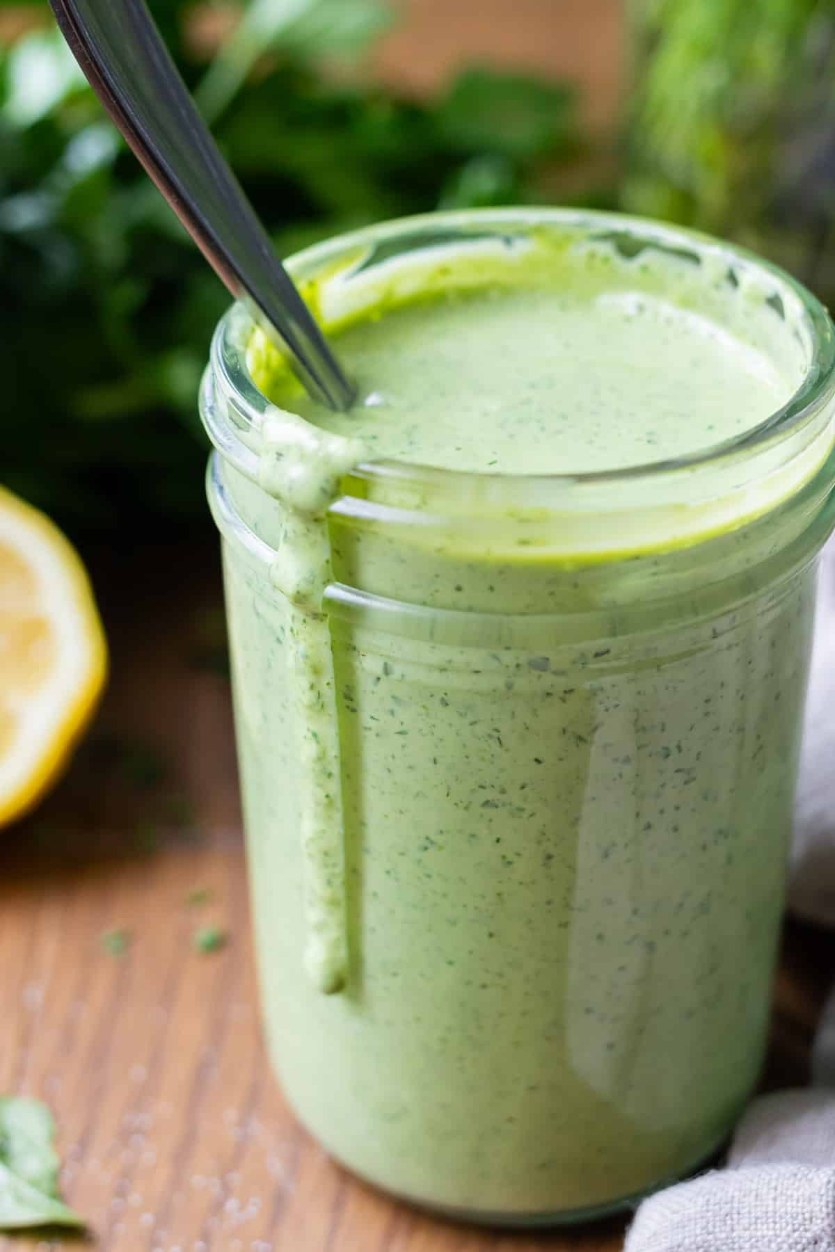 Green goddess dressing in a jar ready to serve