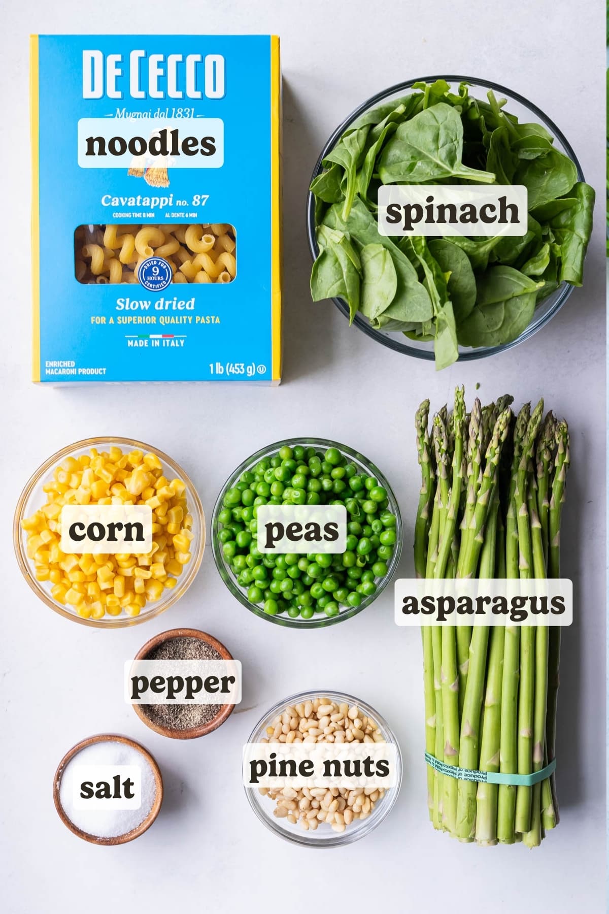 Pasta, spinach, asparagus, corn, peans, salt, pepper, and pine nuts are the main ingredients for this Green Goddess pasta salad recipe.