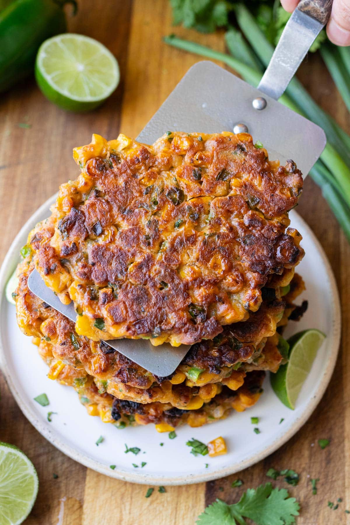 A mexican street corn fritter is placed in a stack on a plate.