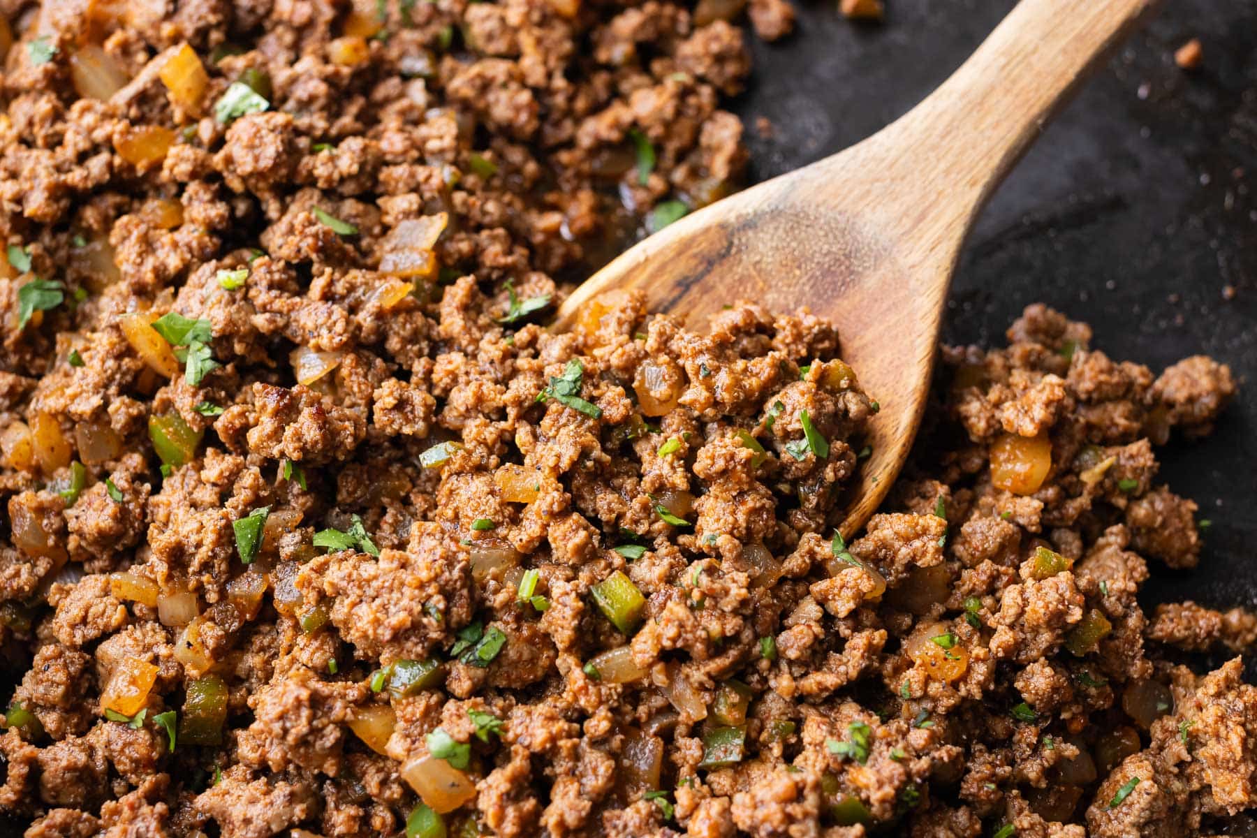 Seasoned ground beef taco meat cooking in a skillet.