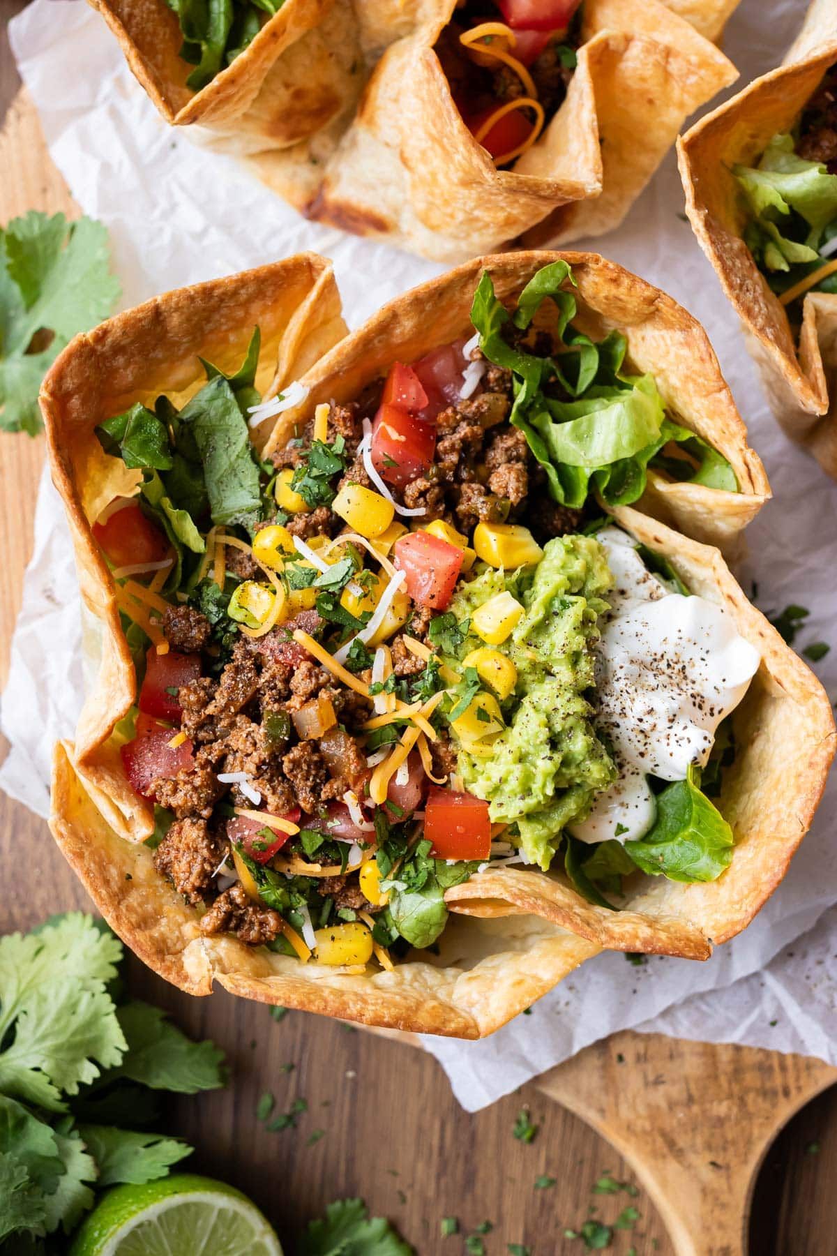 A taco salad bowl with a bubbly tortilla shell.