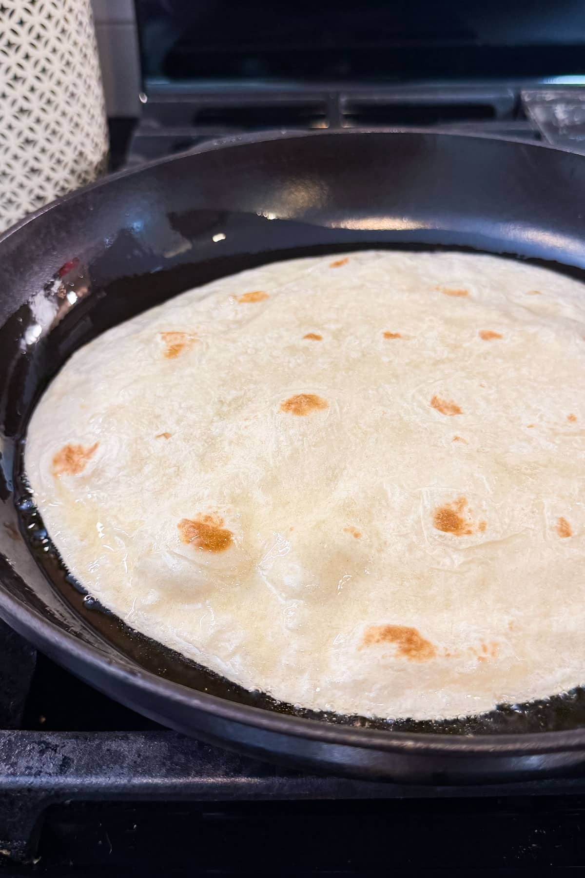 A burrito-sized tortilla is lightly pan-fried to create a bubbly taco shell.