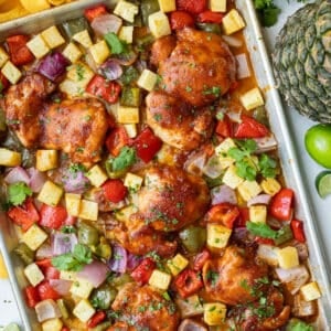 Sheet Pan Hawaiian Chicken with caramelized pineapple, juicy chicken thighs, bell peppers and onions.