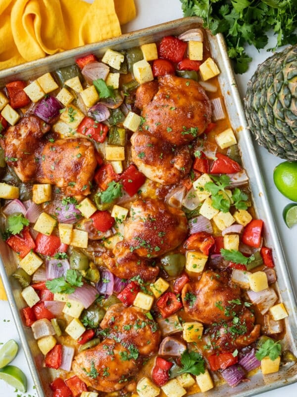 Sheet Pan Hawaiian Chicken with caramelized pineapple, juicy chicken thighs, bell peppers and onions.