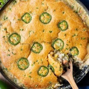 Cornbread Chicken Pot Pie is served in one pan with a jalapeno topping and honey butter.