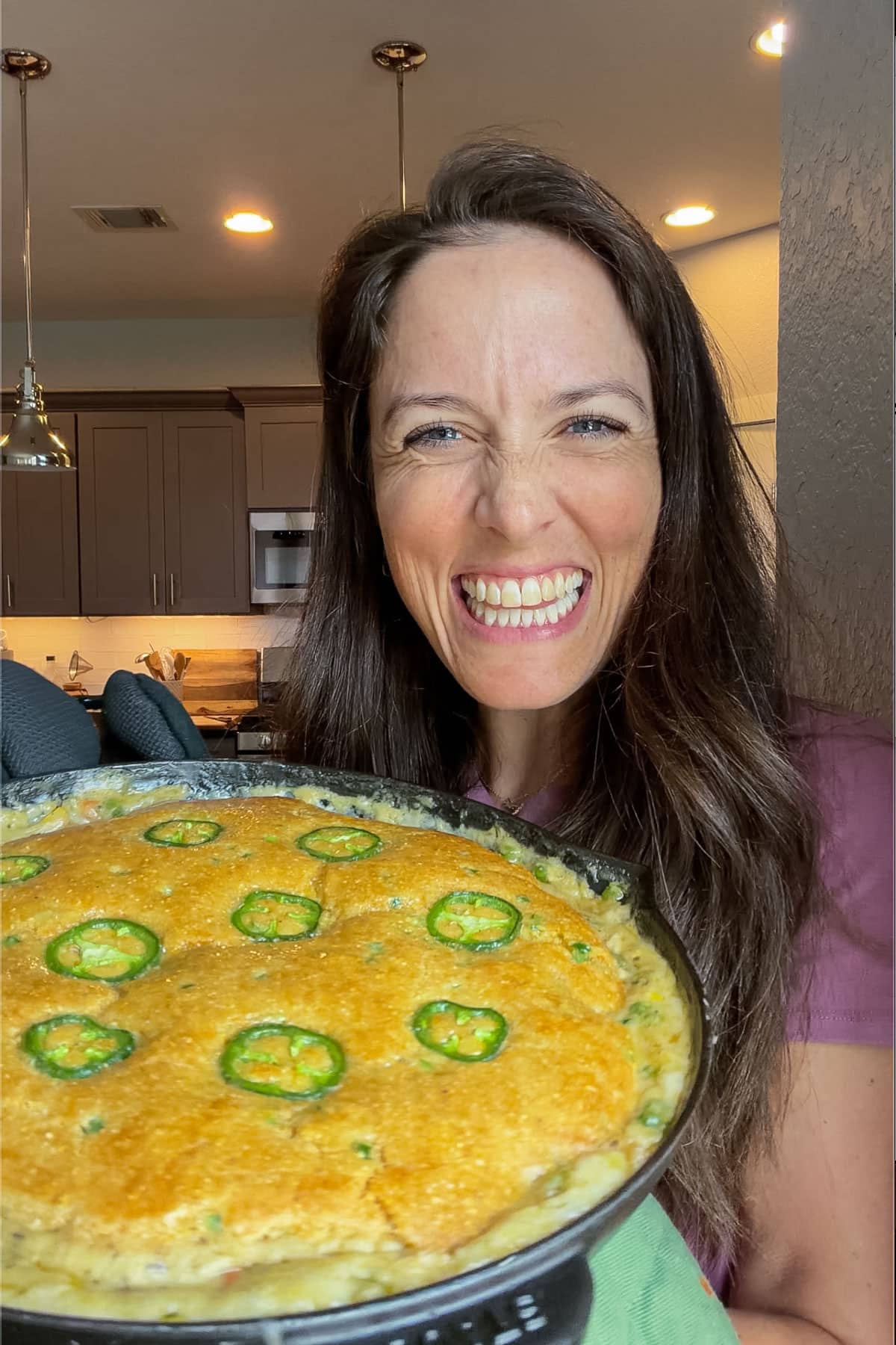 London Lea holding a cornbread chicken pot pie in her Austin, Texas kitchen.