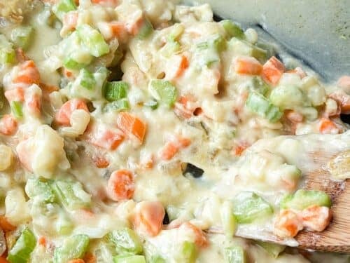 Half and half is added in to make the filling for a chicken pot pie.