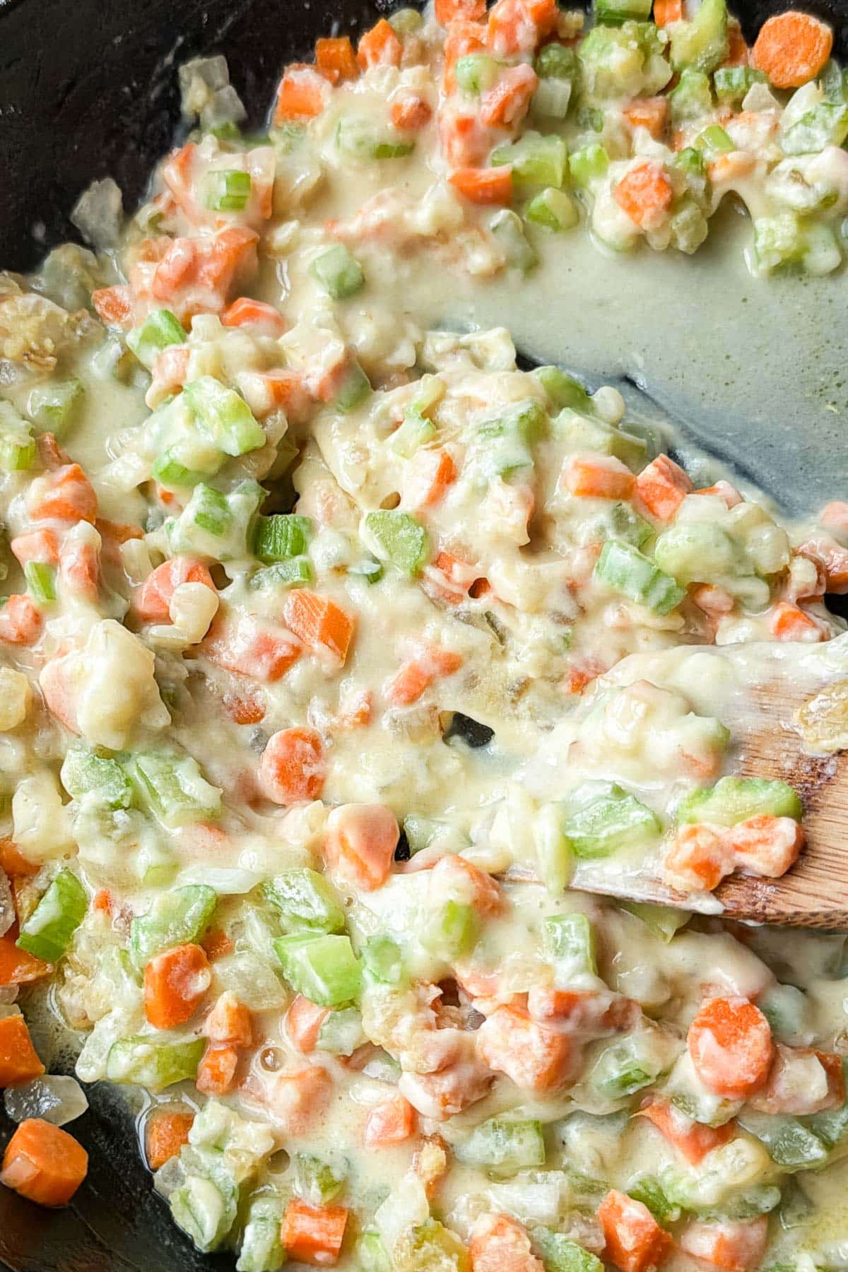 Half and half is added in to make the filling for a chicken pot pie.