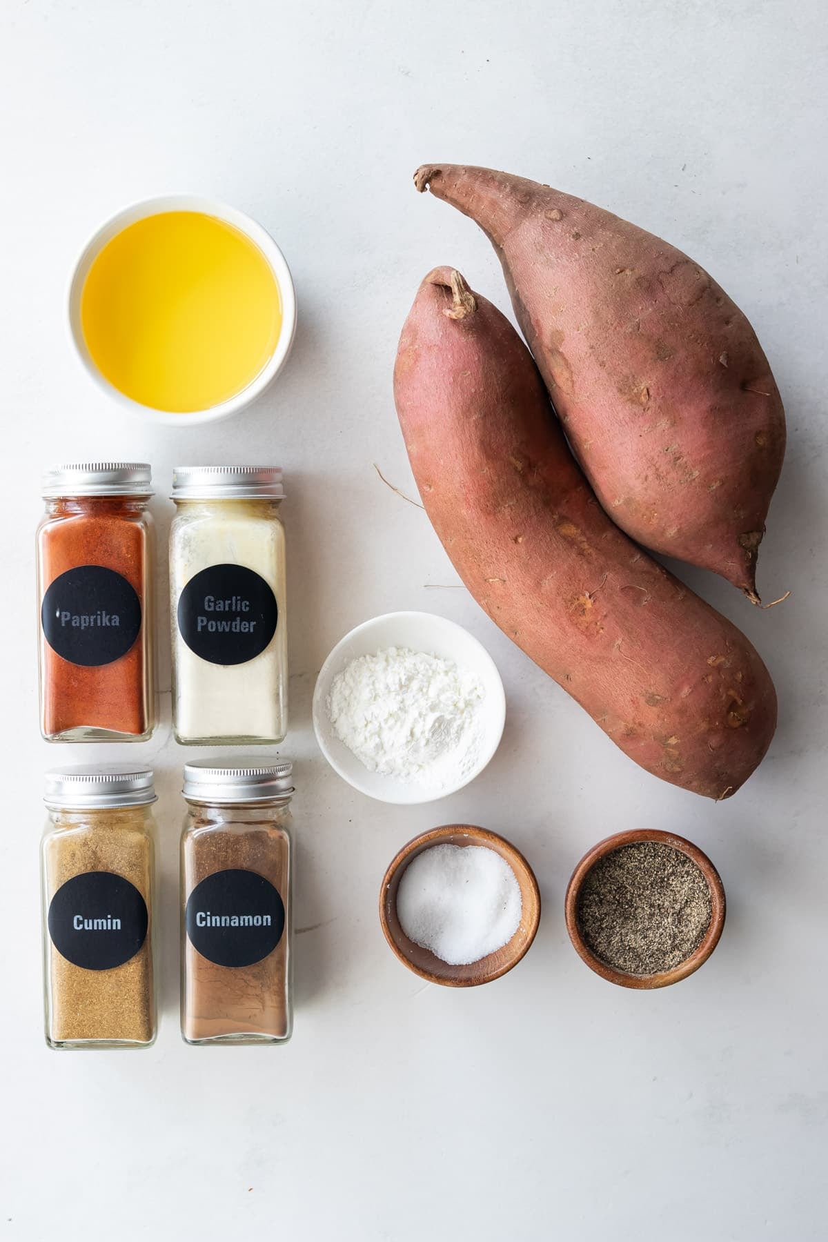 Sweet potatoes, cornstarch, paprika, and garlic powder are the ingredients for crispy roasted sweet potato cubes.