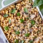 Marry Me Chicken Pasta dump-and-bake recipe is served with fresh basil and Parmesan cheese in a baking dish.