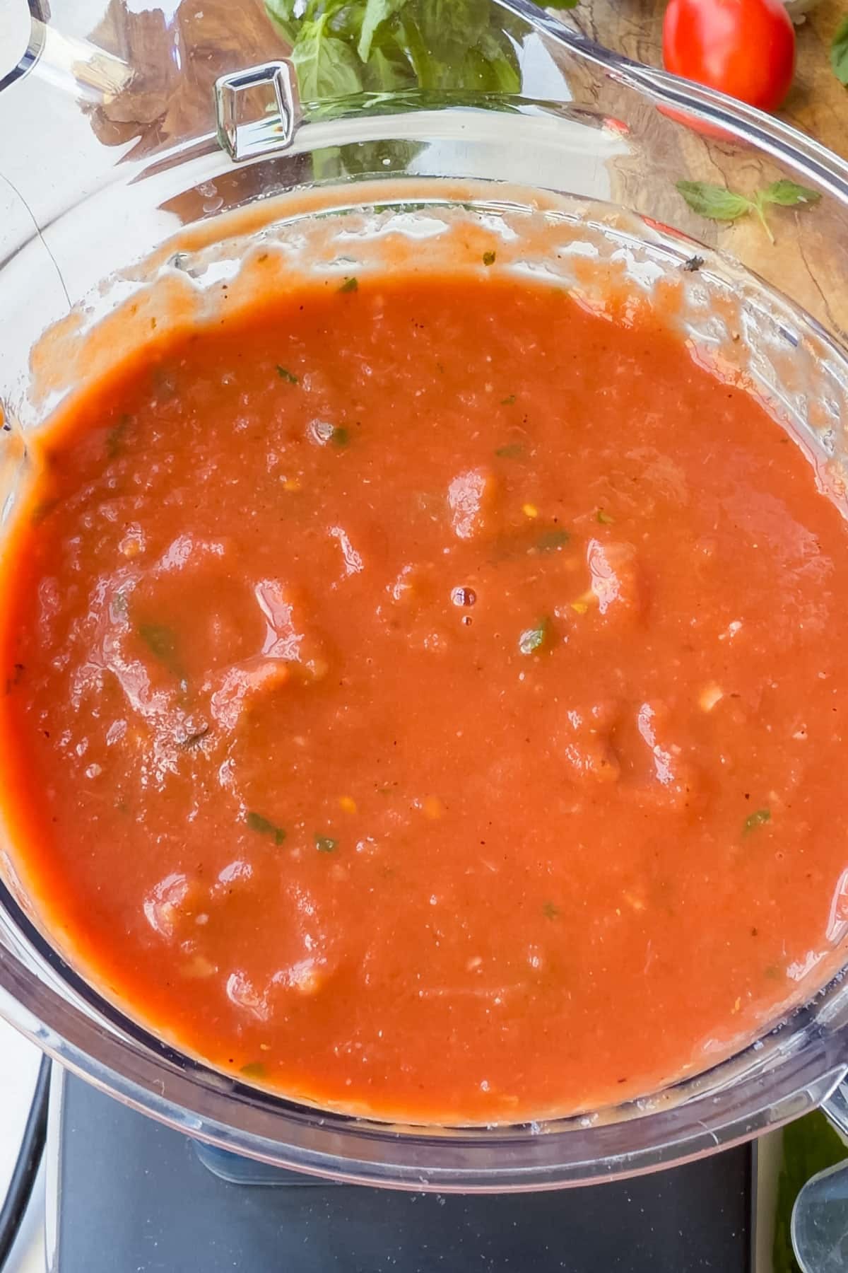 Smooth blended tomato basil soup in a blender pitcher
