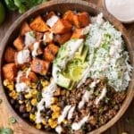 Sweet potato taco bowl with ground taco meat, crispy sweet potatoes, cilantro lime rice and chipotle crema in a bowl.