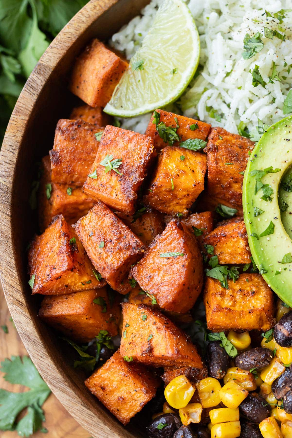 Roasted sweet potato cubes are in a taco bowl.