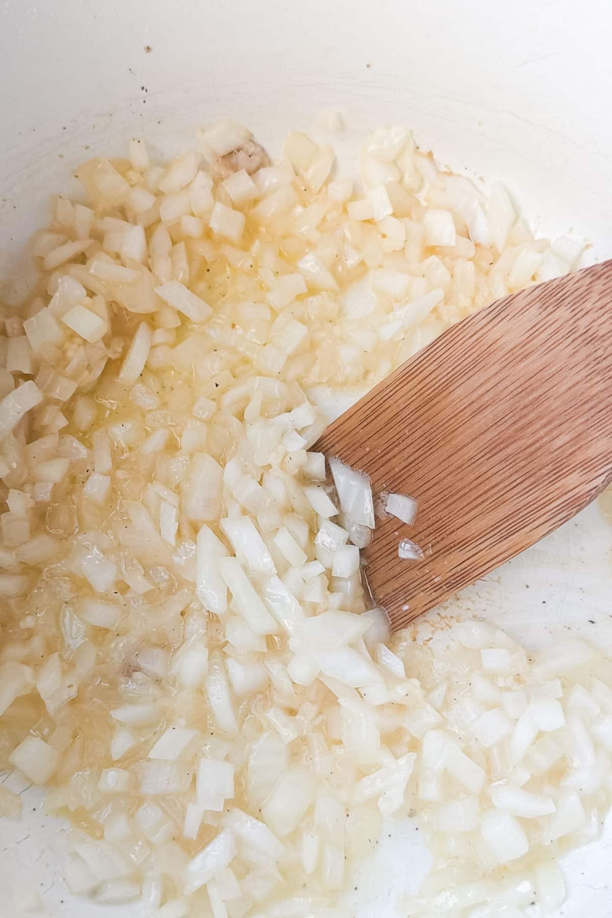 Diced onion softening in butter in a Dutch oven for smoky chicken chili