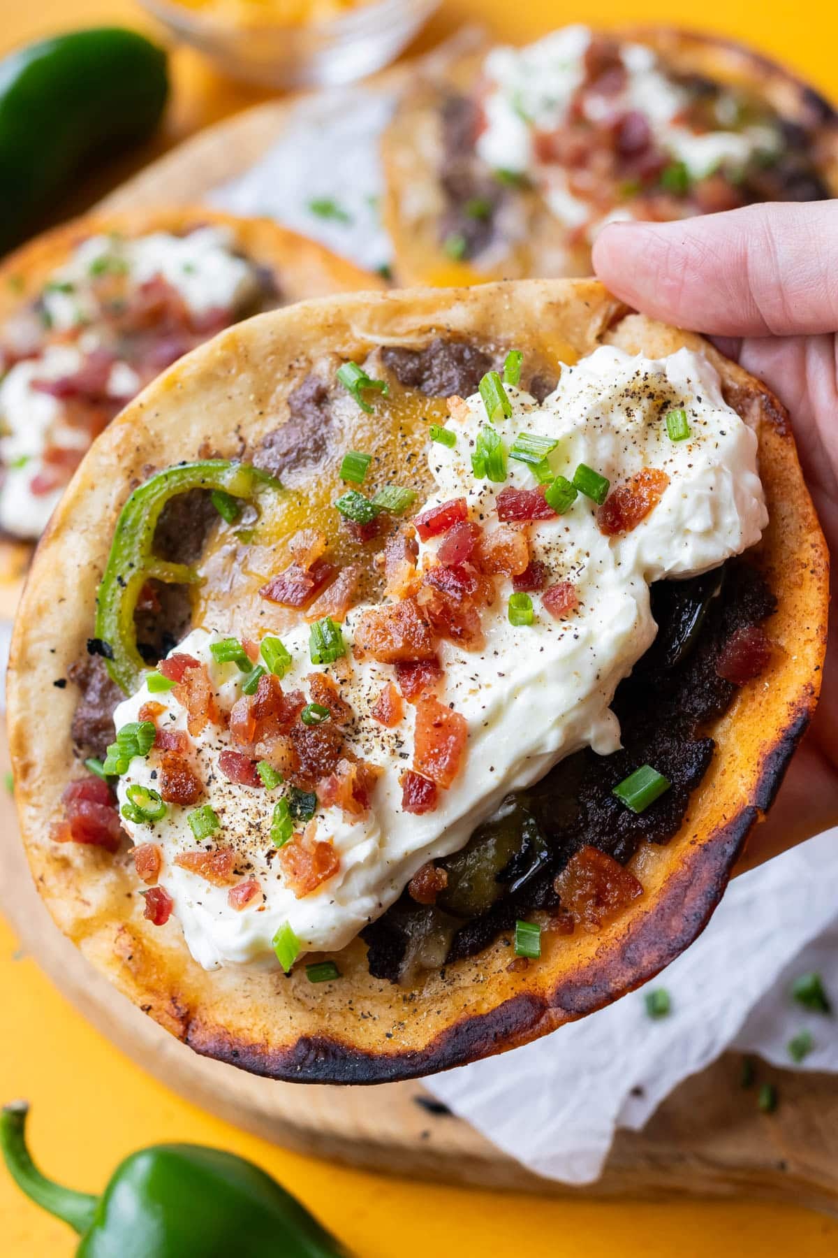 Finished jalapeño popper smashed taco with whipped garlic cream cheese, bacon, and fresh jalapeño