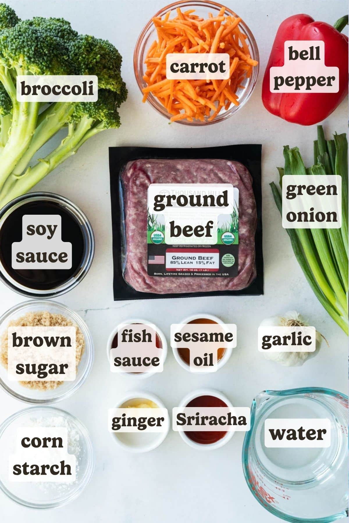 Ingredients for ground beef and broccoli: ground beef, broccoli, matchstick carrots, red bell pepper, green onions, soy sauce, brown sugar, cornstarch, fish sauce, sriracha, sesame oil, ginger, and garlic