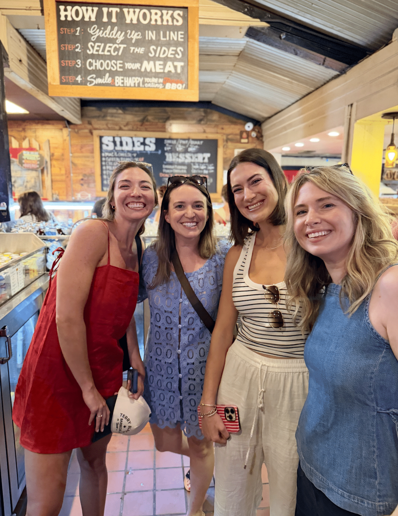 Food bloggers from the Fresh Air Retreat smiling in line at Terry Black's Barbecue in Austin