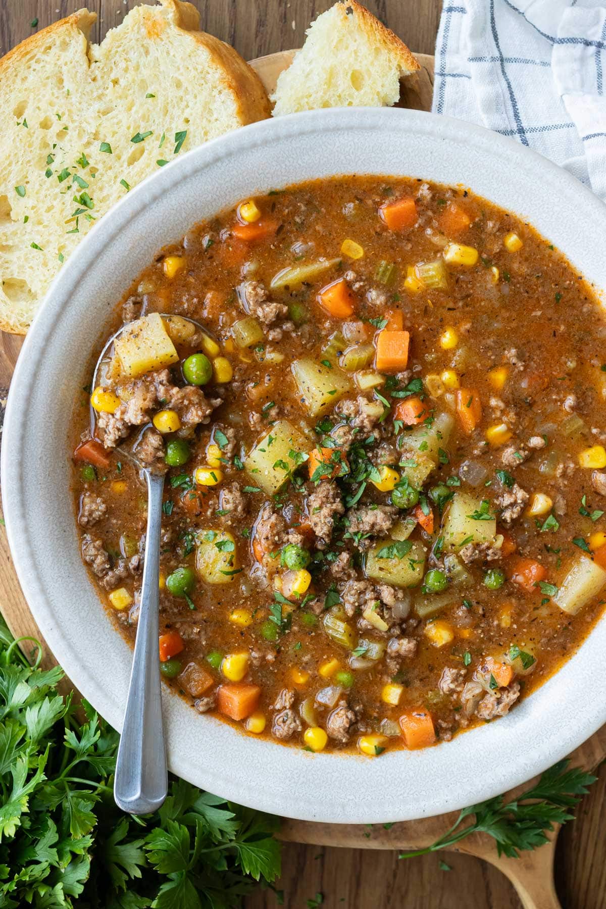 A big bowl of ground beef shepherd's pie soup with potatoes and mixed vegetables in a savory broth.