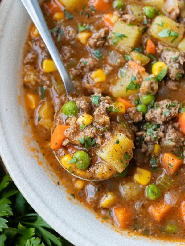 A spoonful of thick shepherd's pie soup made without cream is lifted from a bowl.