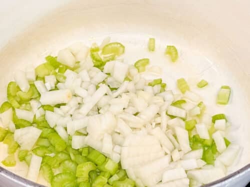 Diced onion and celery cook in a Dutch oven for shepherd's pie soup.