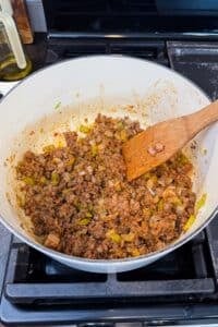 Tomato paste, flour, and seasonings are stirred into the ground beef for shepherd's pie soup.