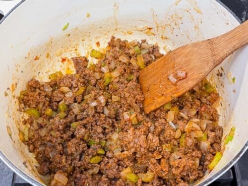 Tomato paste, flour, and seasonings are stirred into the ground beef for shepherd's pie soup.