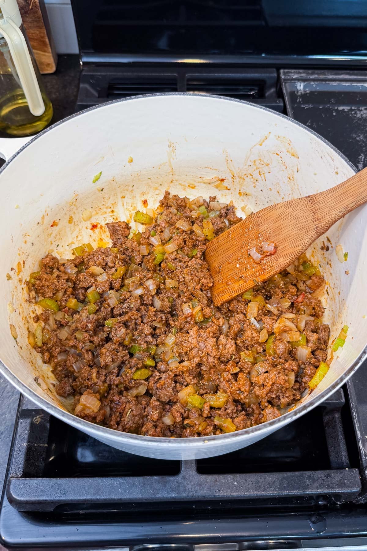 Tomato paste, flour, and seasonings are stirred into the ground beef for shepherd's pie soup.