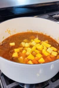 Diced Yukon gold potatoes are added to the beef broth for shepherd's pie soup.