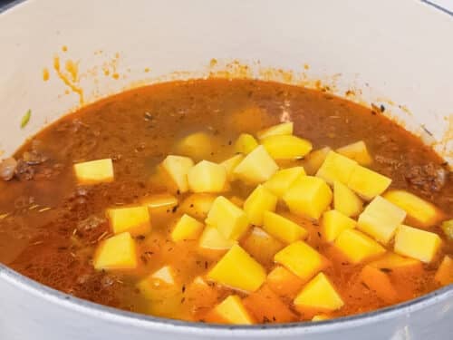 Diced Yukon gold potatoes are added to the beef broth for shepherd's pie soup.