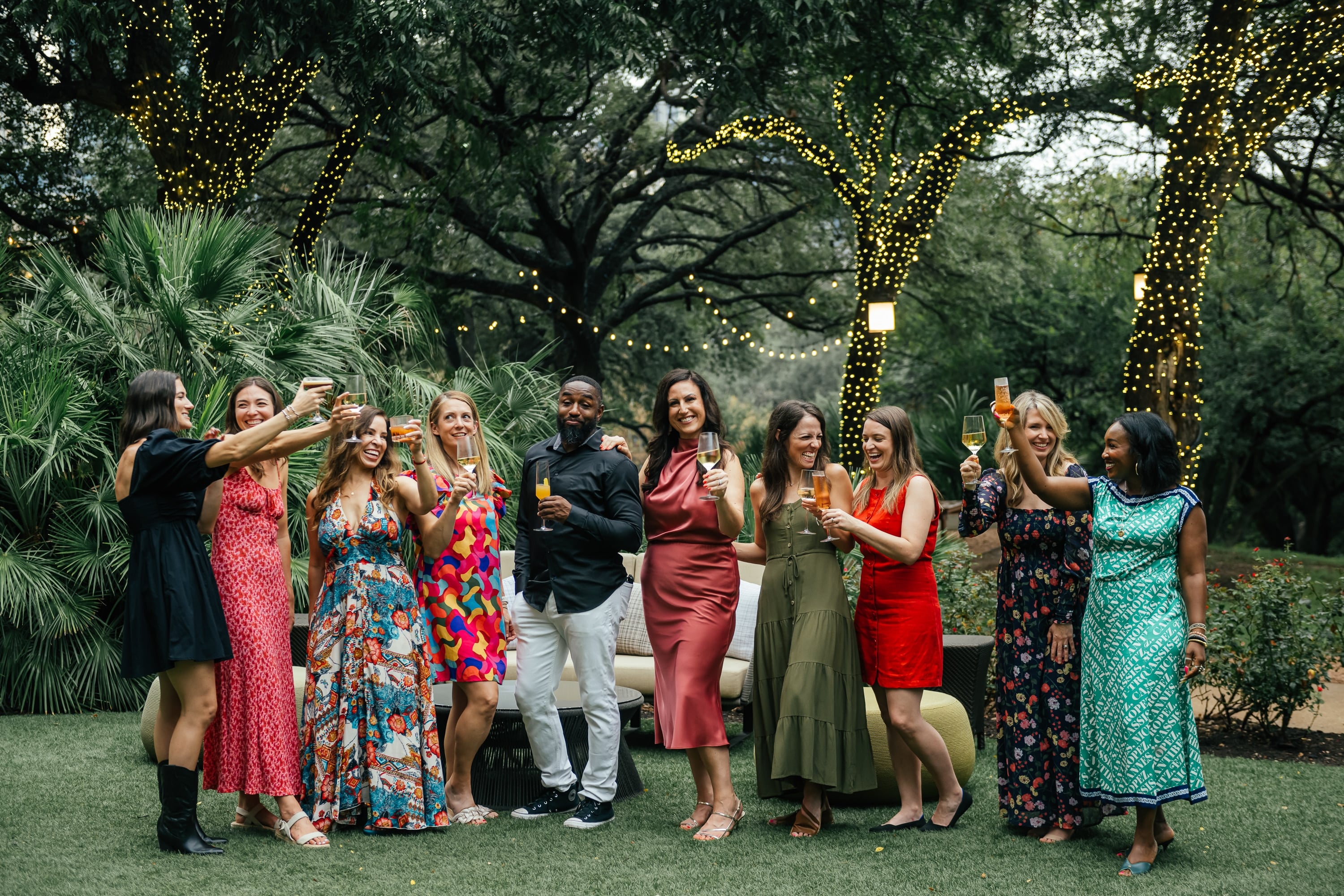 Fresh Air Retreat attendees raising a toast on the lawn at the Four Seasons Austin